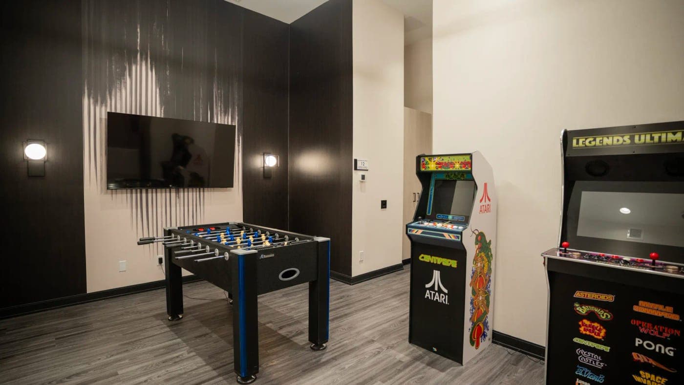 Games room with foosball and arcade machines.